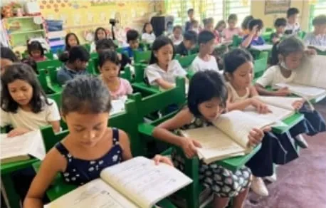 Pupils reading at their new green recycled chairs in a Marcos P. Saez Elementary School classroom